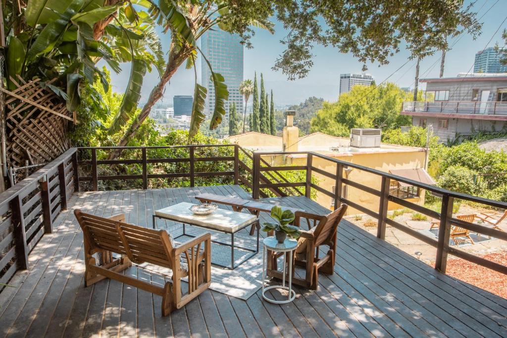 um pátio com uma mesa e cadeiras num deque em Fredonia by AvantStay Great Views of Studio City em Los Angeles