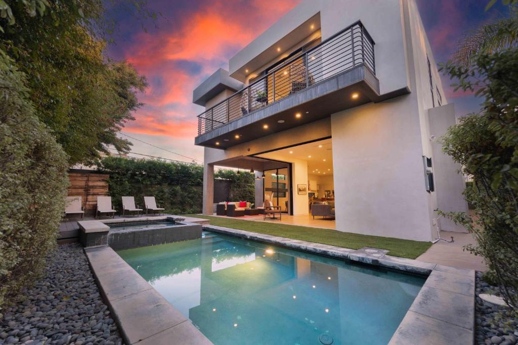 a house with a swimming pool in front of it at LA Villa by AvantStay Walk to The Grove LA in Los Angeles