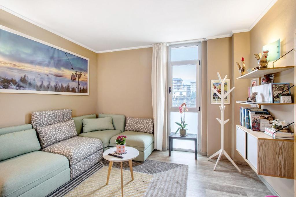 a living room with a couch and a table at Alpen Pila Residence Loft 4 in Aosta