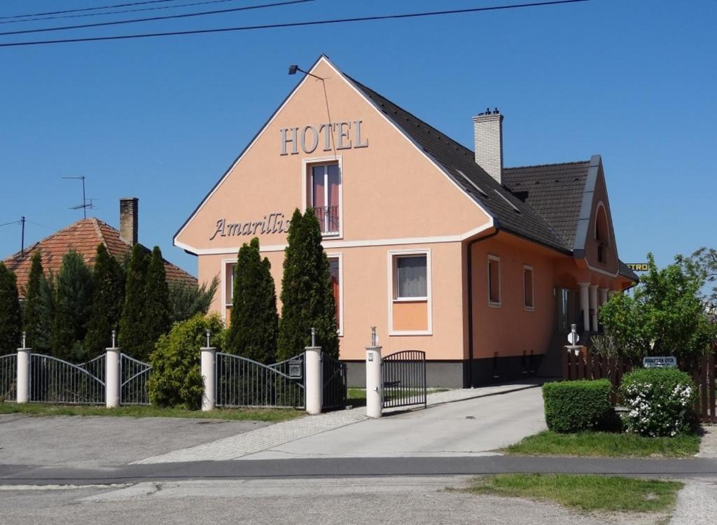 a building with the words hotel on the side of it at Hotel Amarillis in Győr