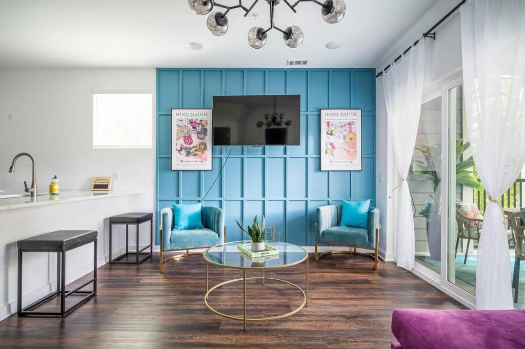 uma sala de estar com paredes azuis e duas cadeiras e uma mesa em New Downtown ATL Condo Washer Dryer 542Blvd107 em Atlanta