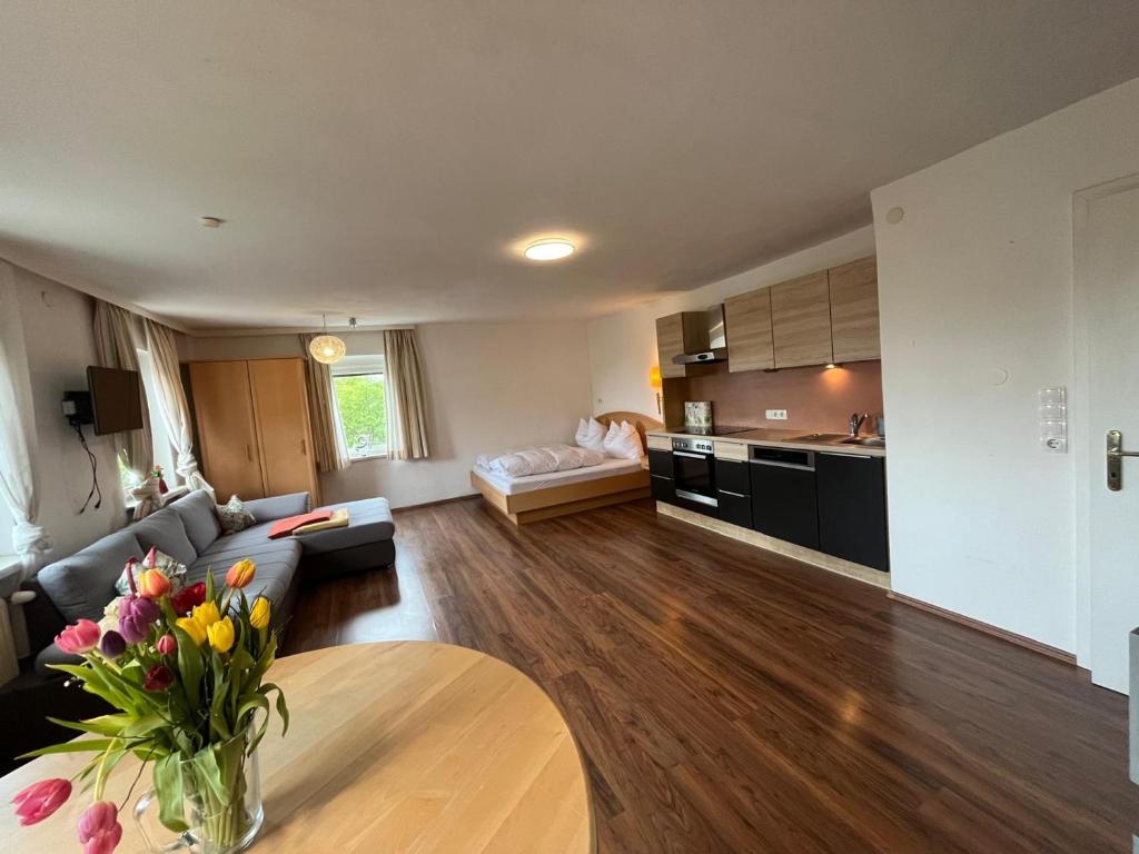 a living room with a couch and a table at Ferienwohnung Rohrbacher Herz in Rohrbach in Oberösterreich