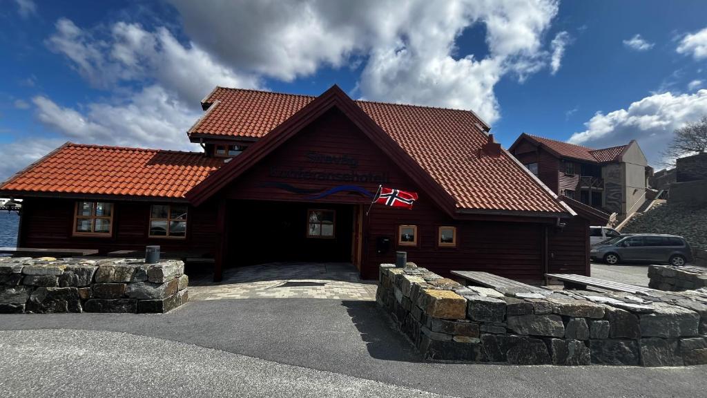 un edificio con una bandera delante de él en Sirevåg Konferansehotell AS en Sirevåg