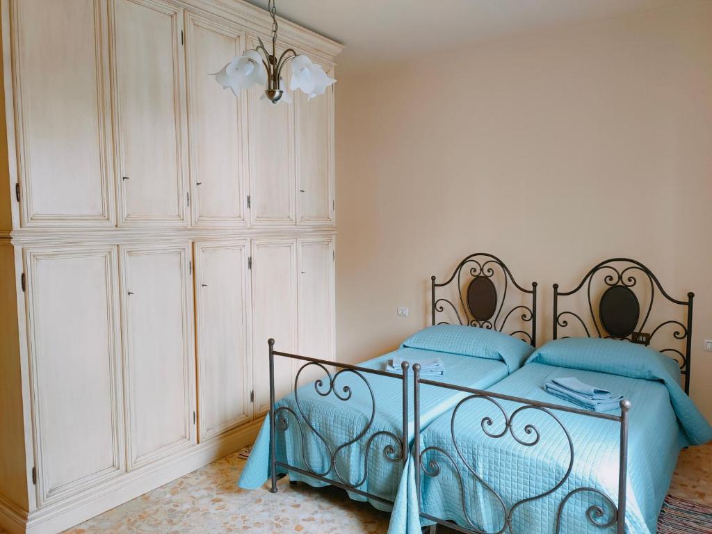 a bedroom with a bed and a large white cabinet at Casa ANNA in Montevarchi