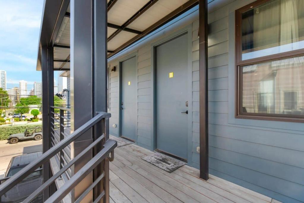 a front porch of a house with a blue door at Modern Condo with Parking - B in Austin