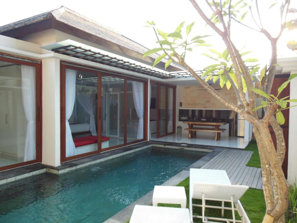 a pool in the backyard of a villa at HK Villa Bali in Legian
