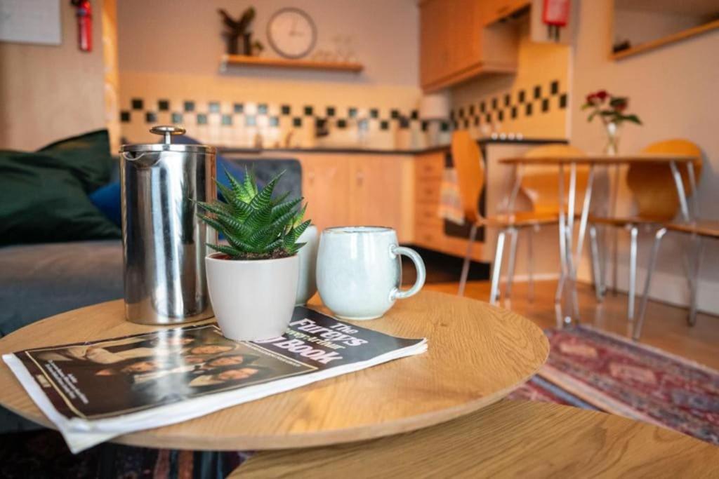 a table with a coffee pot and a plant on it at Modern apartment in the Heart of Sligo Town in Sligo