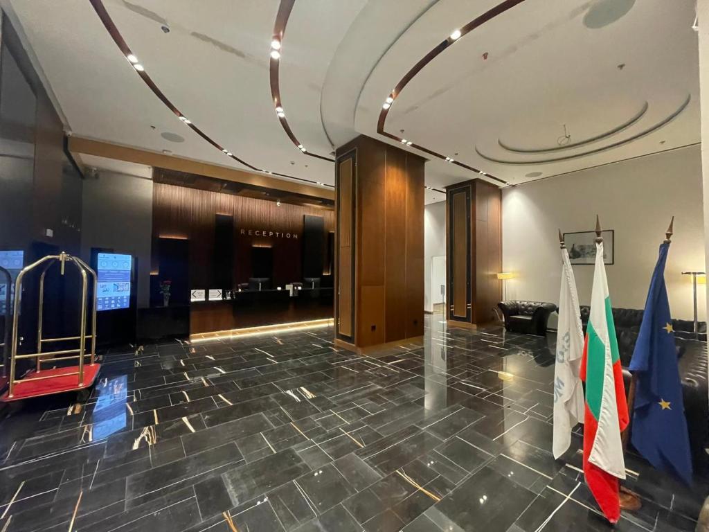 a lobby with a flag and a basketball court at Hotel & Casino Cherno More in Varna City