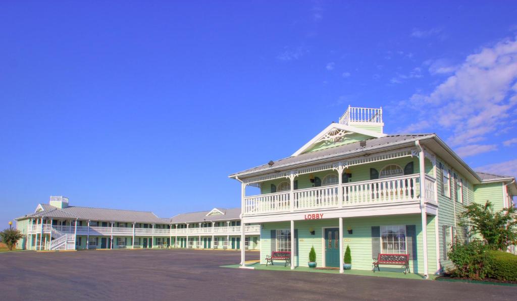 a large white building with a large parking lot at Key West Inn - Tunica Resort in Tunica Resorts