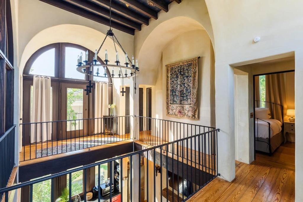 a hallway with a chandelier in a house at European Influences in the Heart of Charleston in Charleston