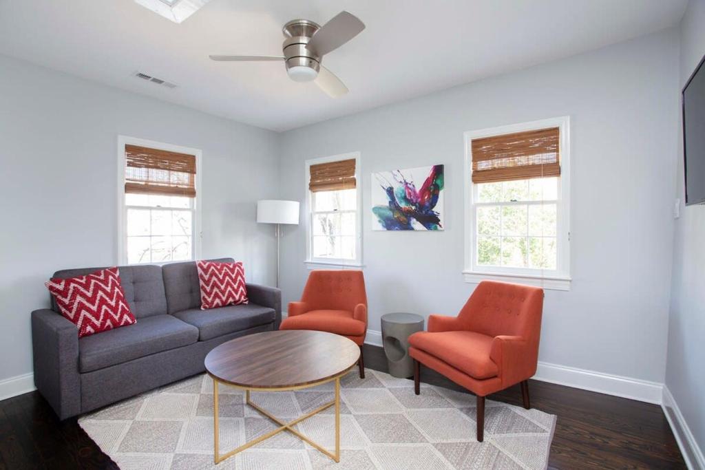 a living room with a couch and two chairs at Freshly Renovated 2 Bedroom Apt 1 Block to King in Charleston