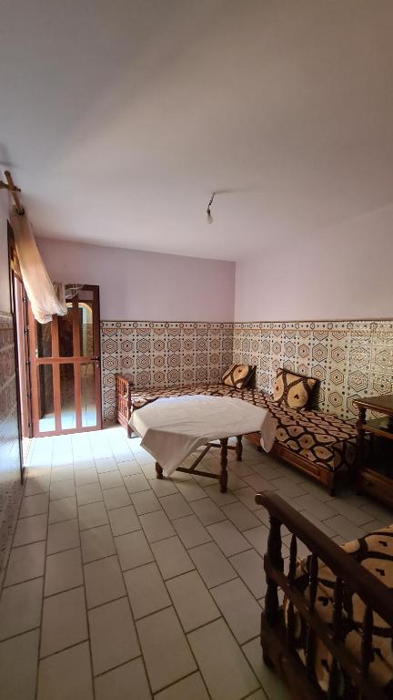a room with a bed and a tiled floor at saidia beach in Saidia 