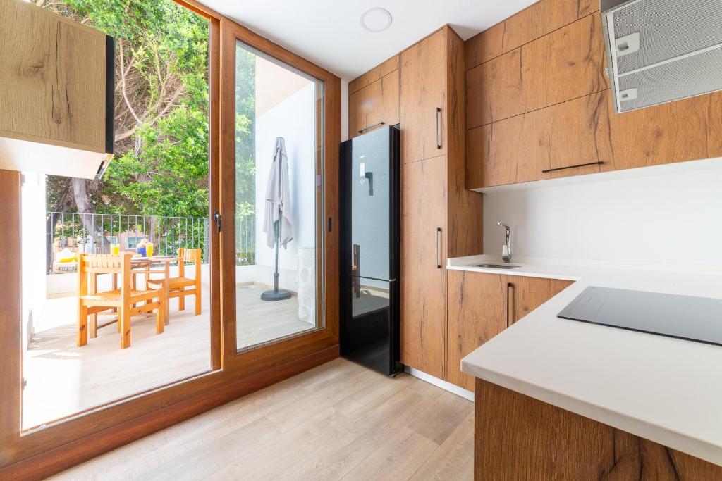 a kitchen with a sliding glass door leading to a patio at Las Terrazas de Casa Gómez in Almería