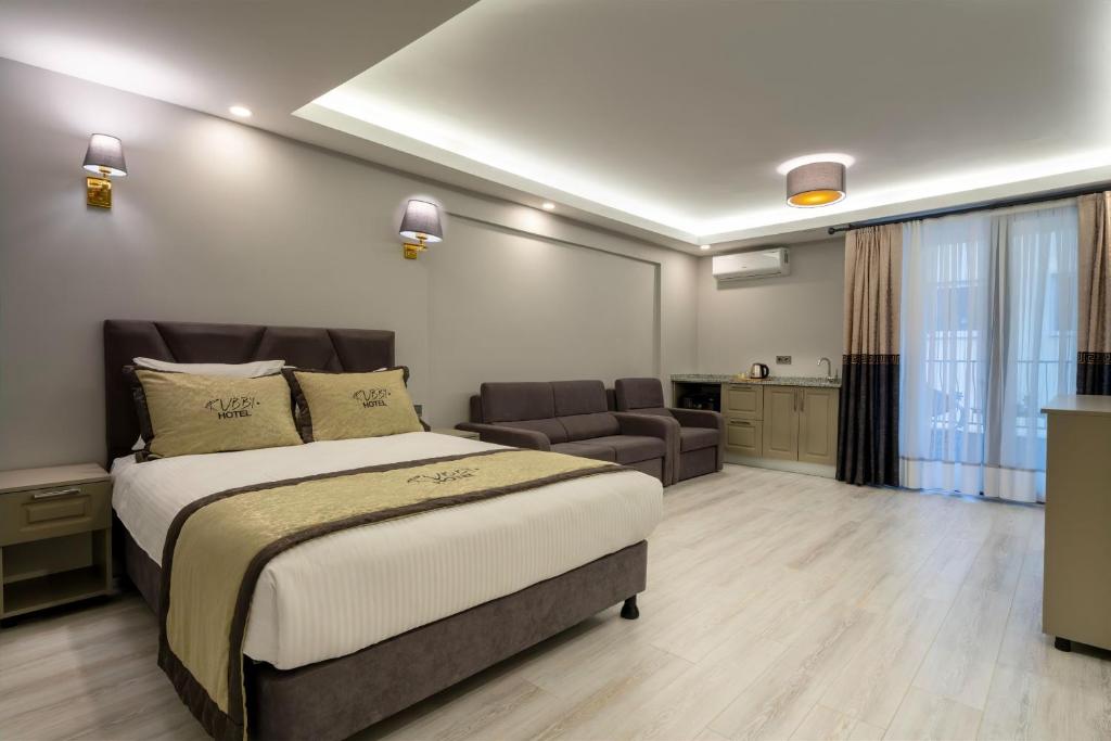a bedroom with a large bed and a living room at Rubby Hotel Kadıköy in Istanbul