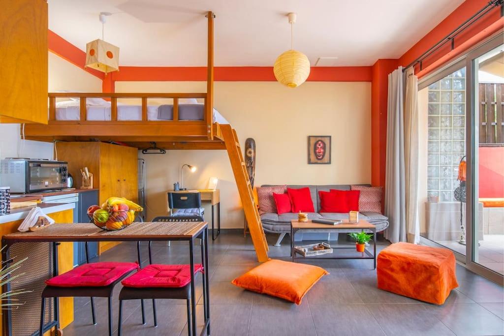 ein Wohnzimmer mit einem Hochbett und einer Küche in der Unterkunft The HostMaster Ethnic Touch Feel Studio in Athen