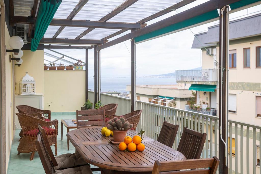 a table with fruit on top of a balcony at Casa Patty Sorrento in Sorrento