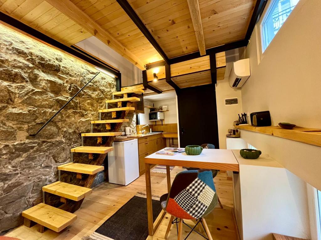 a kitchen with a wooden staircase and a table and chairs at Balloon Boutique House, City Centre in Plovdiv