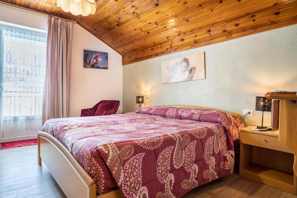 フォルガリーアにあるHouse Cuel Milena Folgaria - Greenの木製の天井が特徴のベッドルーム1室(ベッド1台付)
