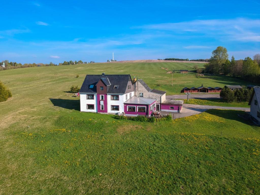 an aerial view of a house in a field at Bergheisl Rübenau in Rübenau