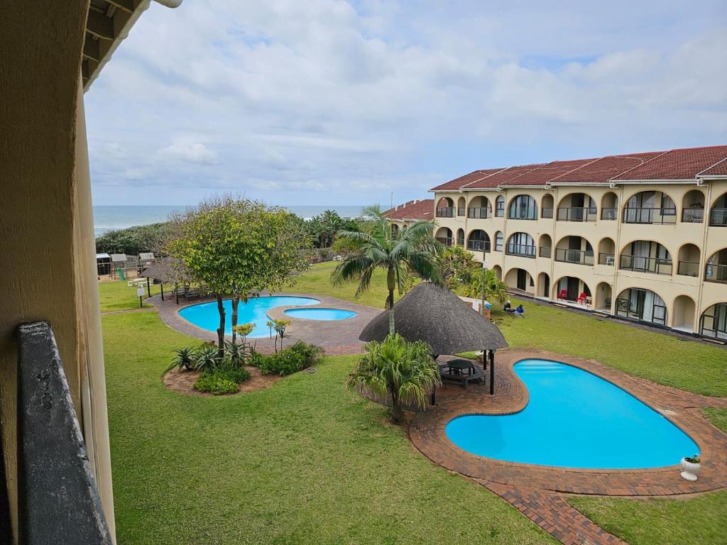 an aerial view of a resort with two pools at 78 Cabanas Del Mar in Kingsburgh