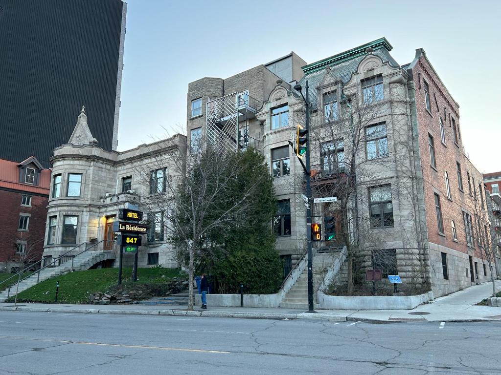 un gran edificio de ladrillo en la esquina de una calle en Hotel La Residence du Voyageur, en Montreal