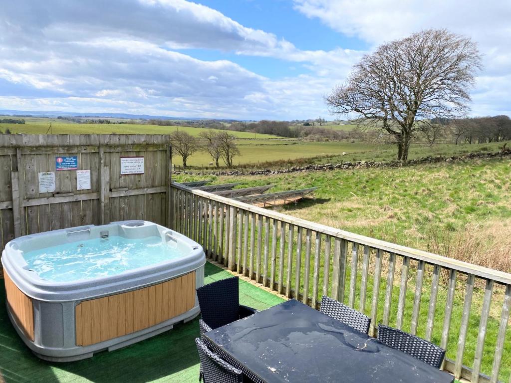 a hot tub on the deck of a house at Torridon 12 with Private Hot Tub - Fife - Loch Leven - Lomond Hills in Kelty