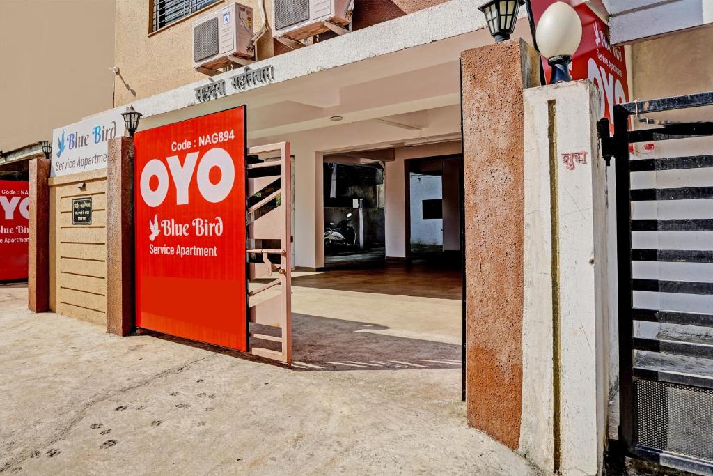 an open door of a building with a sign on it at OYO Flagship BlueBird Service Apartment in Nagpur