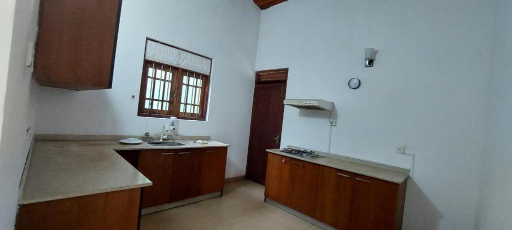 a large kitchen with a sink and a window at Villa in Hikkaduwa in Dodanduwa