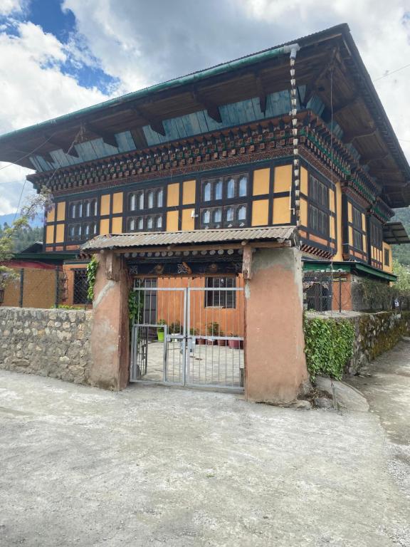 a building with a gate in front of it at Amas Village Lodge in Paro