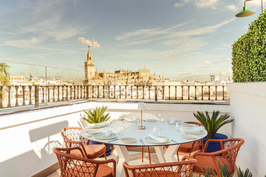 a table on a balcony with a view of the city at Vincci La Rabida in Seville