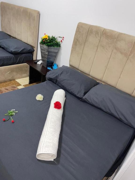 a remote control on a bed in a room at Explore Stars Pyramids View in Cairo