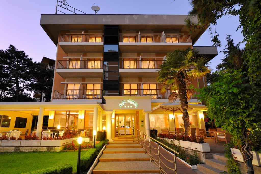 a building with a staircase leading up to it at Hotel Niagara in Lignano Sabbiadoro