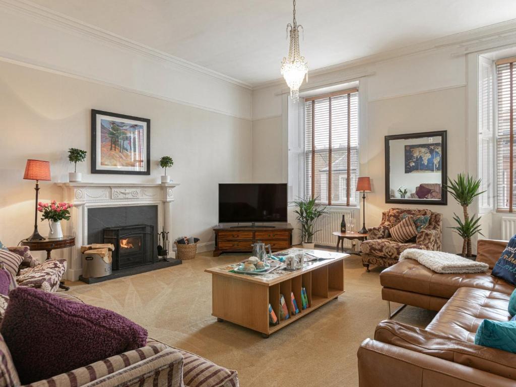 a living room with couches and a fireplace at 5 Bed in Melrose 79418 in Melrose