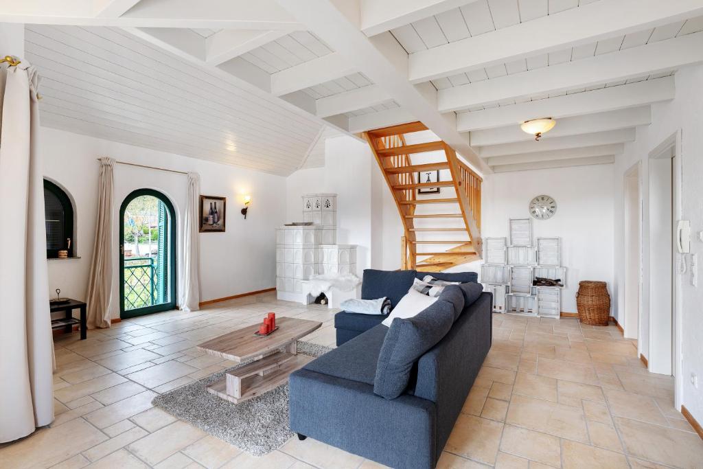 a living room with a blue couch and a table at Ferienwohnung Weingut Löwenthal in Eschbach