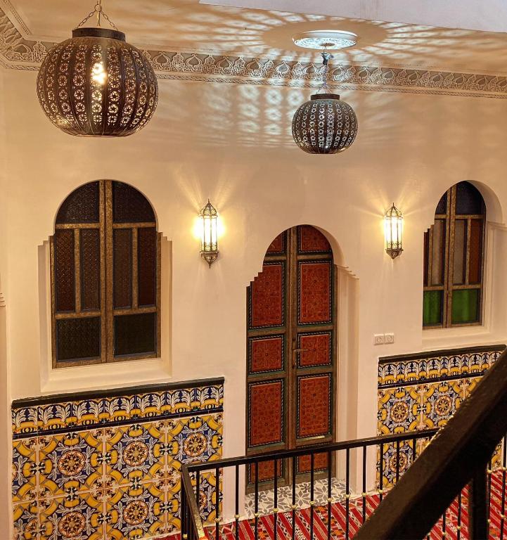 a building with two doors and a staircase with lights at Zoco Riad in Tangier