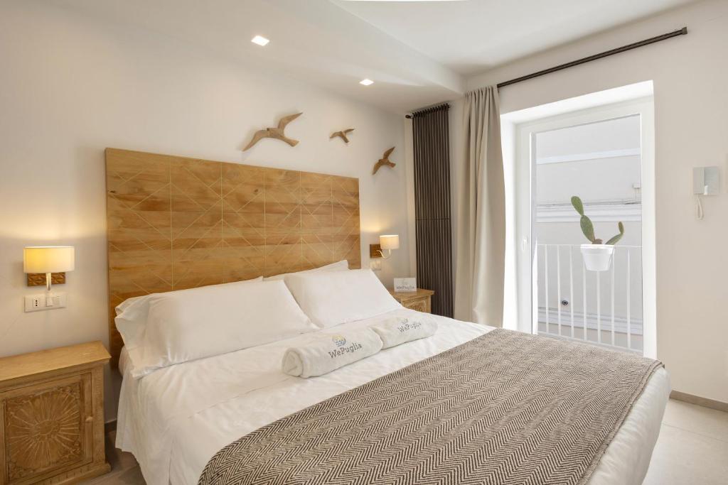 una camera da letto con un grande letto con uccelli che volano sopra di esso di WePuglia - Vista Cattedrale a Monopoli