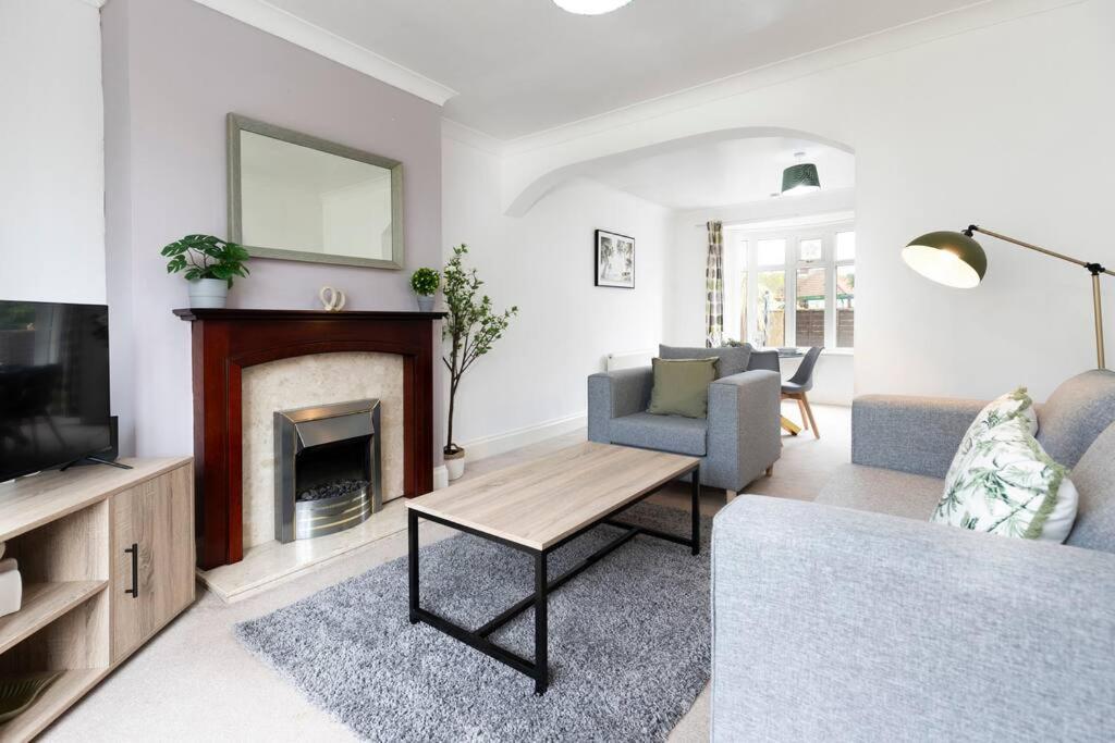 a living room with a couch and a fireplace at Beautiful & comfortable home in Stockton-on-Tees
