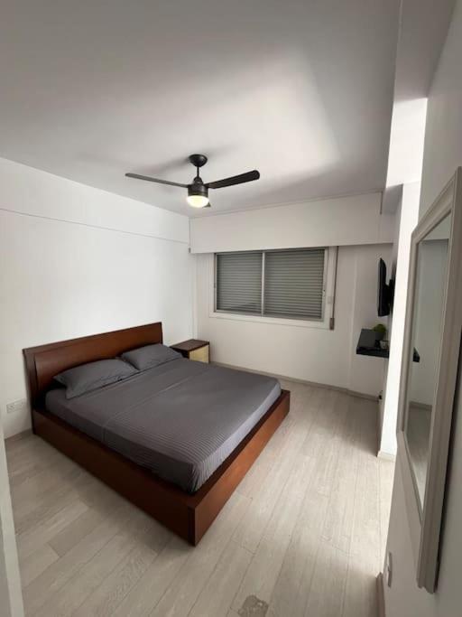 a bedroom with a bed and a ceiling fan at Top floor Flat in Nicosia 2 in Nicosia