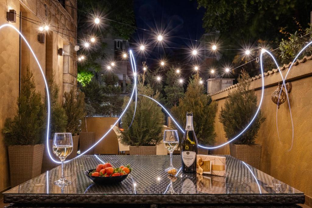 a table with wine glasses and a bowl of fruit at Hidden Bank: Pearls in Plovdiv