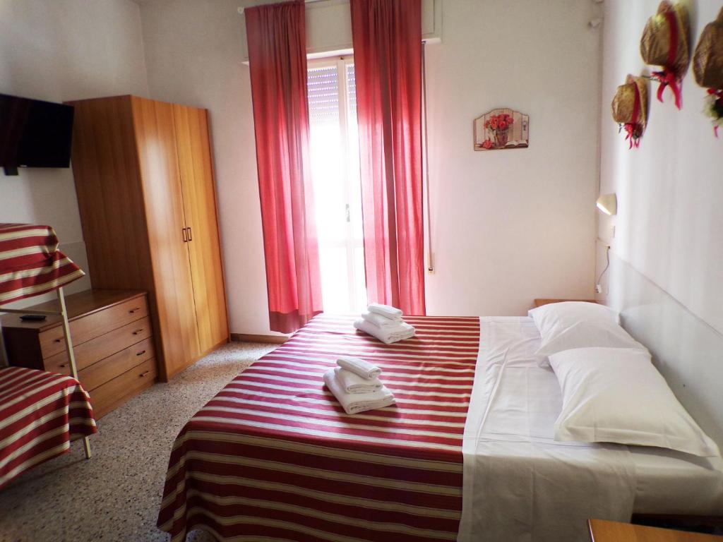 Postel nebo postele na pokoji v ubytování Hotel Graziella Mare