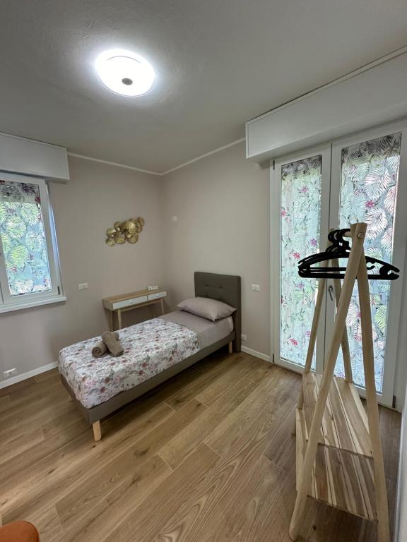a bedroom with a bed and two windows at Camera Manzoni Difronte San Siro in Milan