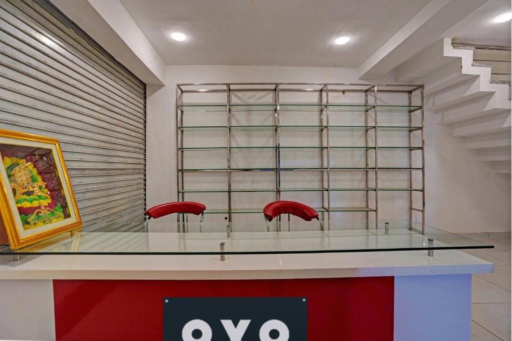 a display case in a store with two red chairs at OYO Hotel AXN RESORT in Panchli