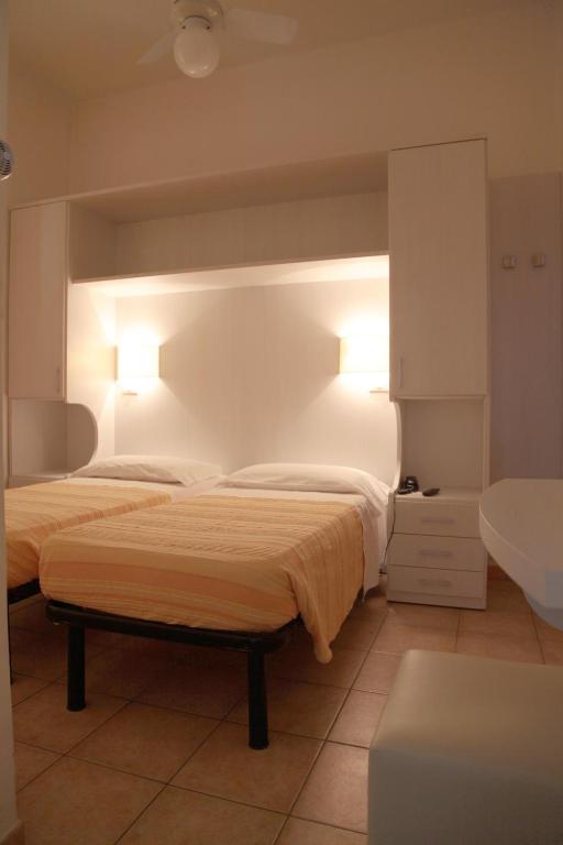Postel nebo postele na pokoji v ubytování Hotel Gardenia