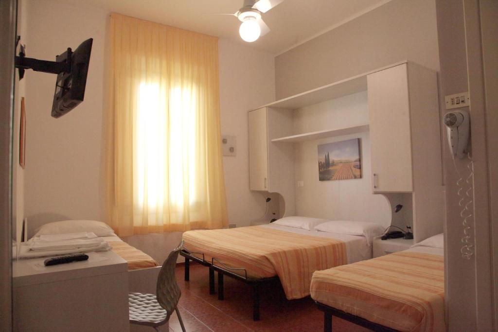 Postel nebo postele na pokoji v ubytování Hotel Gardenia
