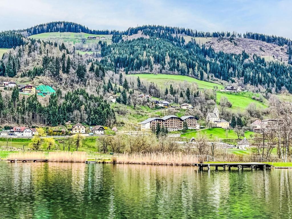 a view of a lake with houses and a mountain at Apartment Wolf by Interhome in Sankt Urban
