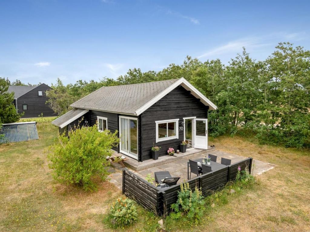 ein winziges Haus mit einer Terrasse im Hof in der Unterkunft Holiday Home Oddger - all inclusive - 250m to the inlet by Interhome in Skjern