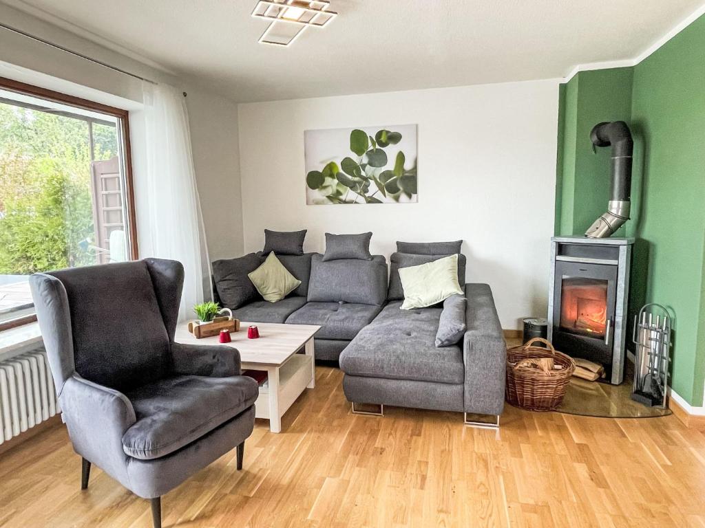 a living room with a couch and chairs and a fireplace at Apartment Auszeit by Interhome in Oy-Mittelberg