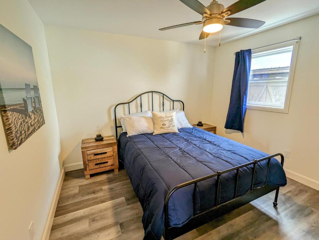 a bedroom with a bed and a ceiling fan at Newly Renovated 3 Bedroom Beach Front Condo 3B in Lanark