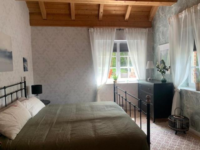 a bedroom with a large bed and a window at Ferienwohnung Landhaus Scholz in Bad Münder am Deister