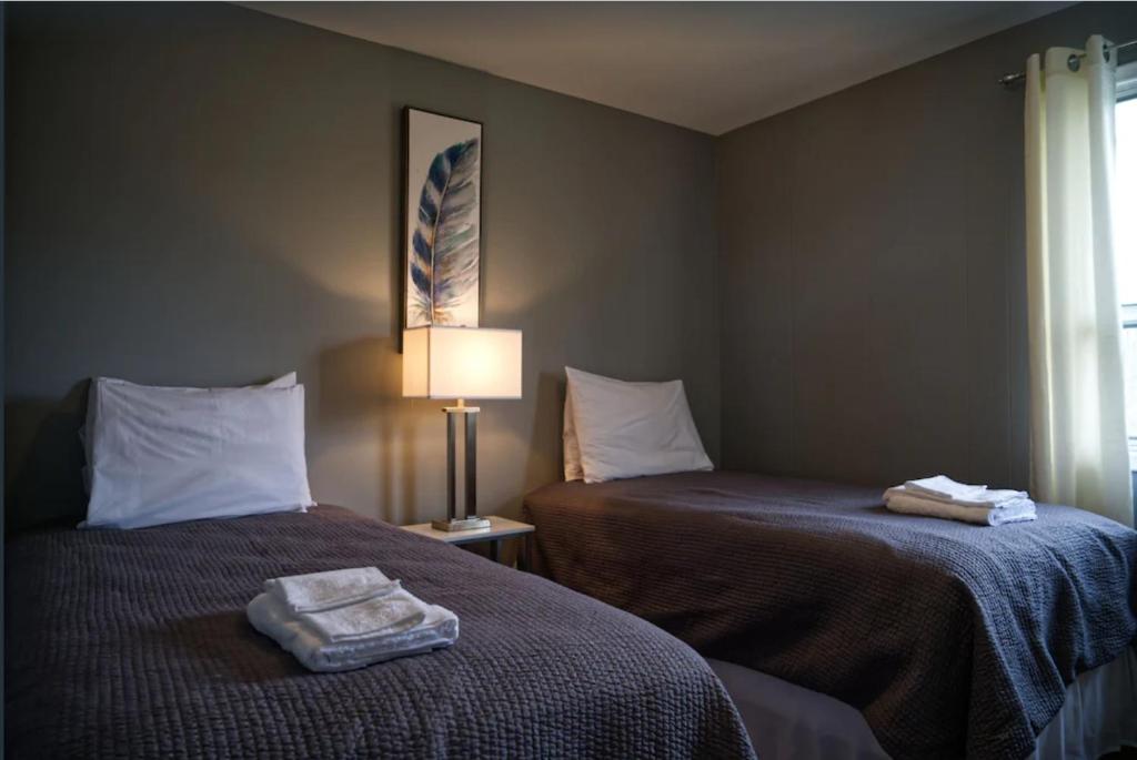a hotel room with two beds with towels on them at 2 Bedroom Harbor Front Condo 10U in Roseneath